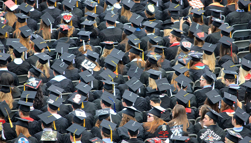 A see of college graduates at the commencement ceremony.