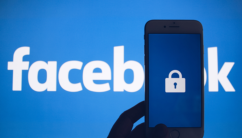 Facebook logo with smartphone showing lock in front